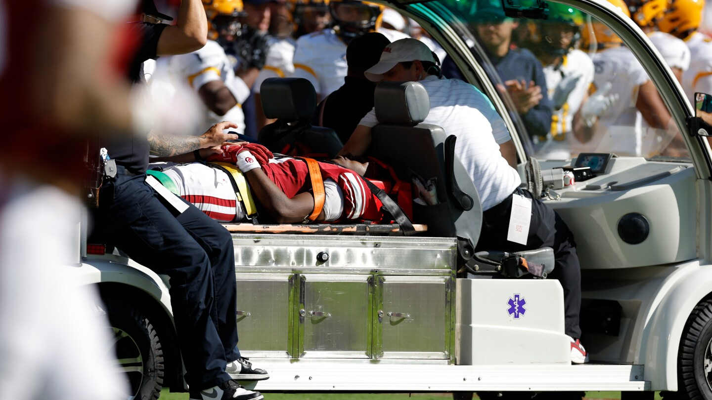 Oklahoma WR Keontez Lewis exits after a headfirst slam into a brick barrier during the game